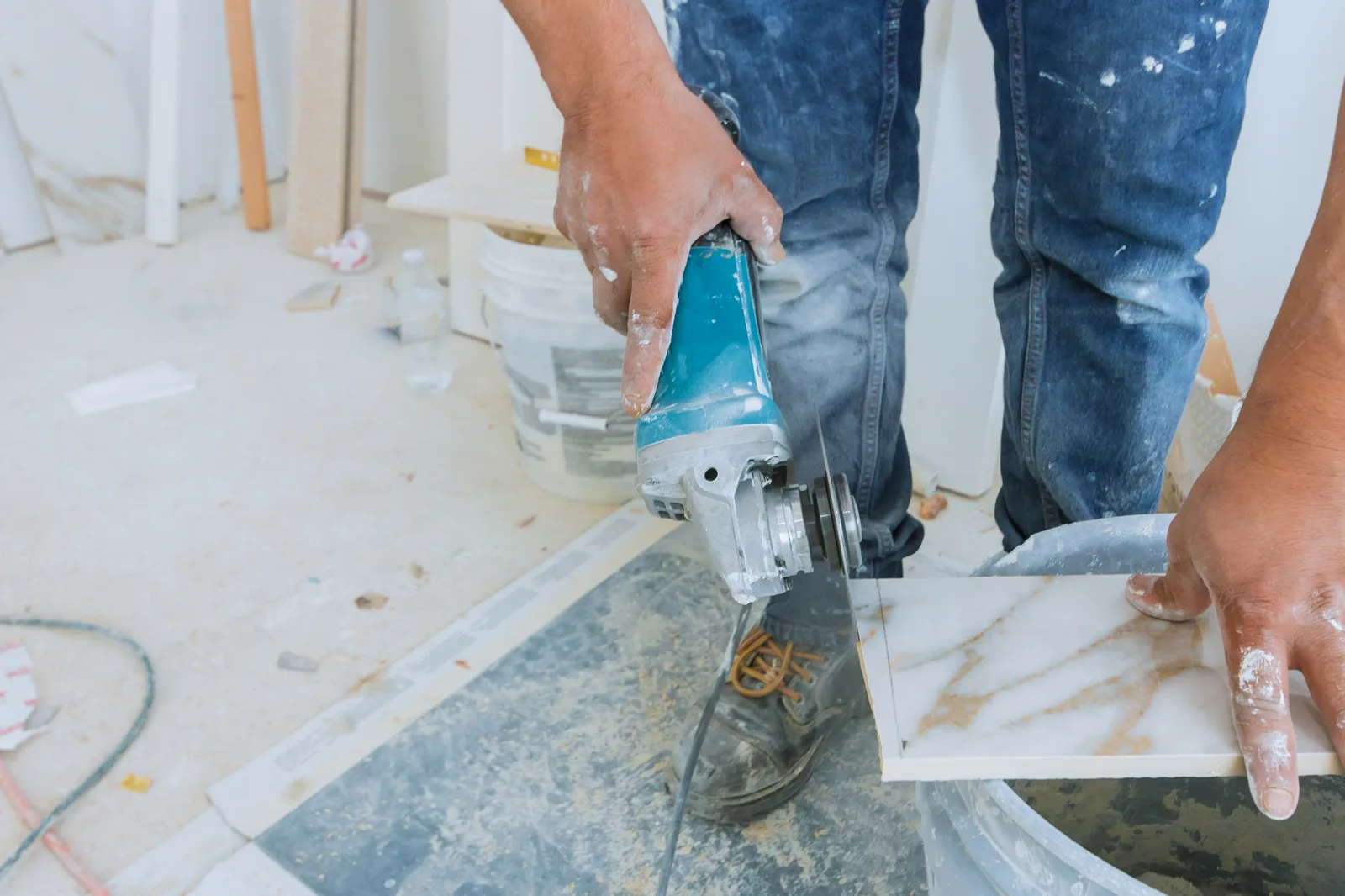 Tiler cutting a porcelain tile